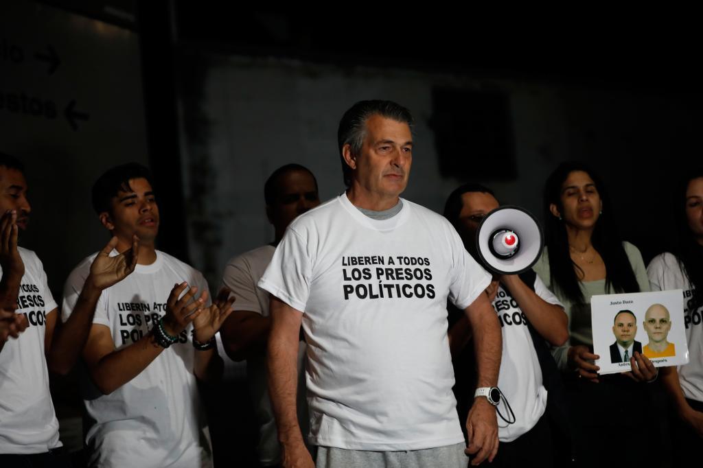 Opposition politician Roberto Vernet stands with relatives of people they consider political prisoners