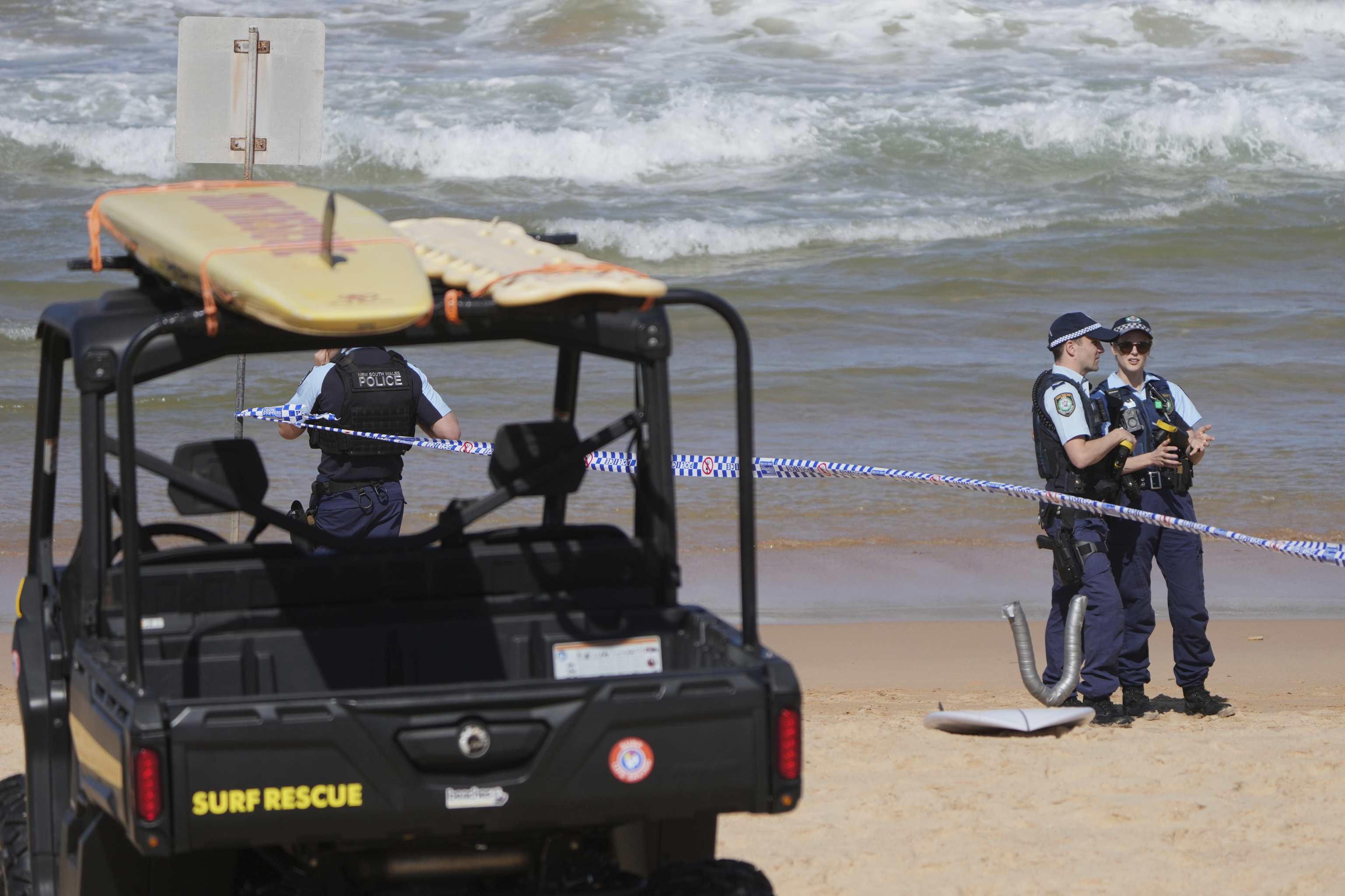 Police work at the site of a fatal shark attack at Dee Why Beach in Sydney.