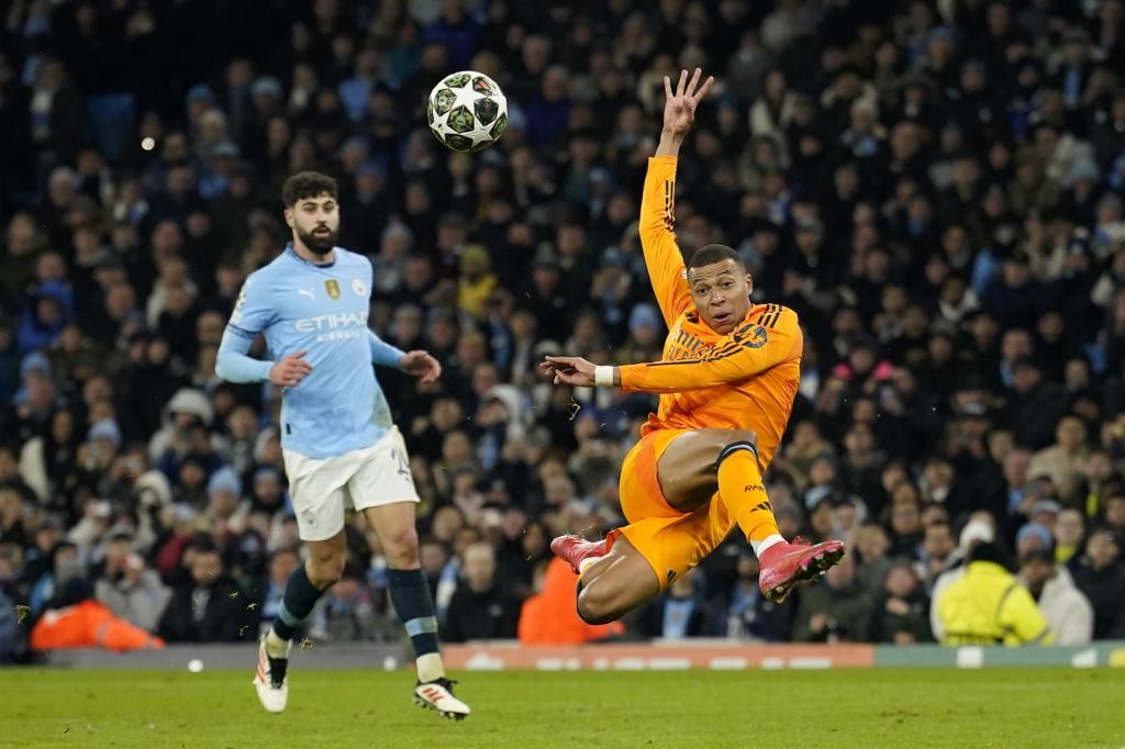 Real Madrid's Kylian Mbappe scores his sides first goal during the Champions League playoff first leg soccer match between Manchester City and Real Madrid