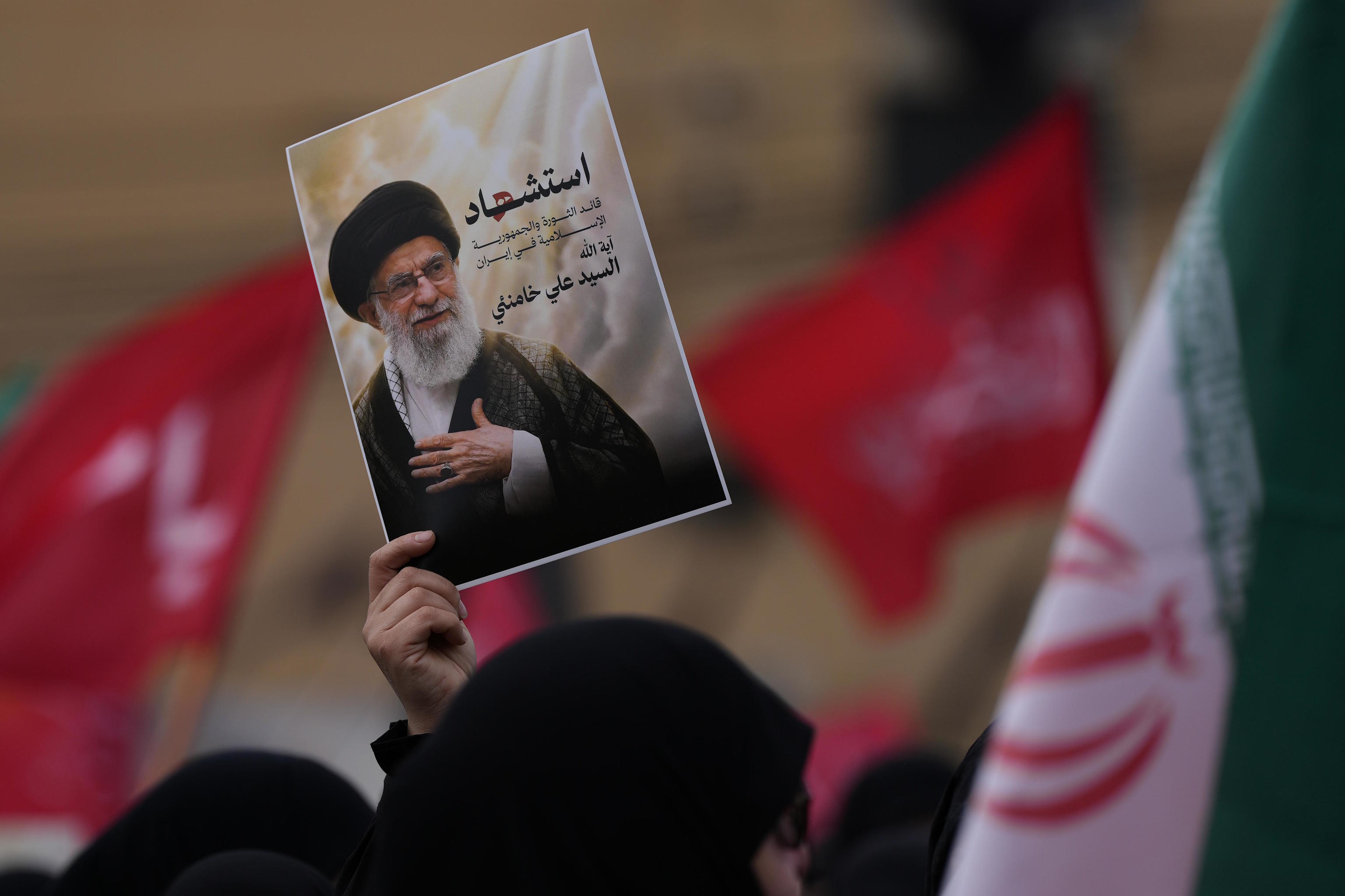 A Hezbollah supporter holds a portrait of the late Iranian Supreme Leader, Ayatollah Ali Khamenei.
