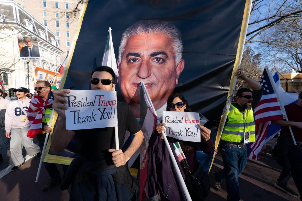 Demonstrators carrying a photograph of Reza Pahlavi protesting against the Islamic republic
