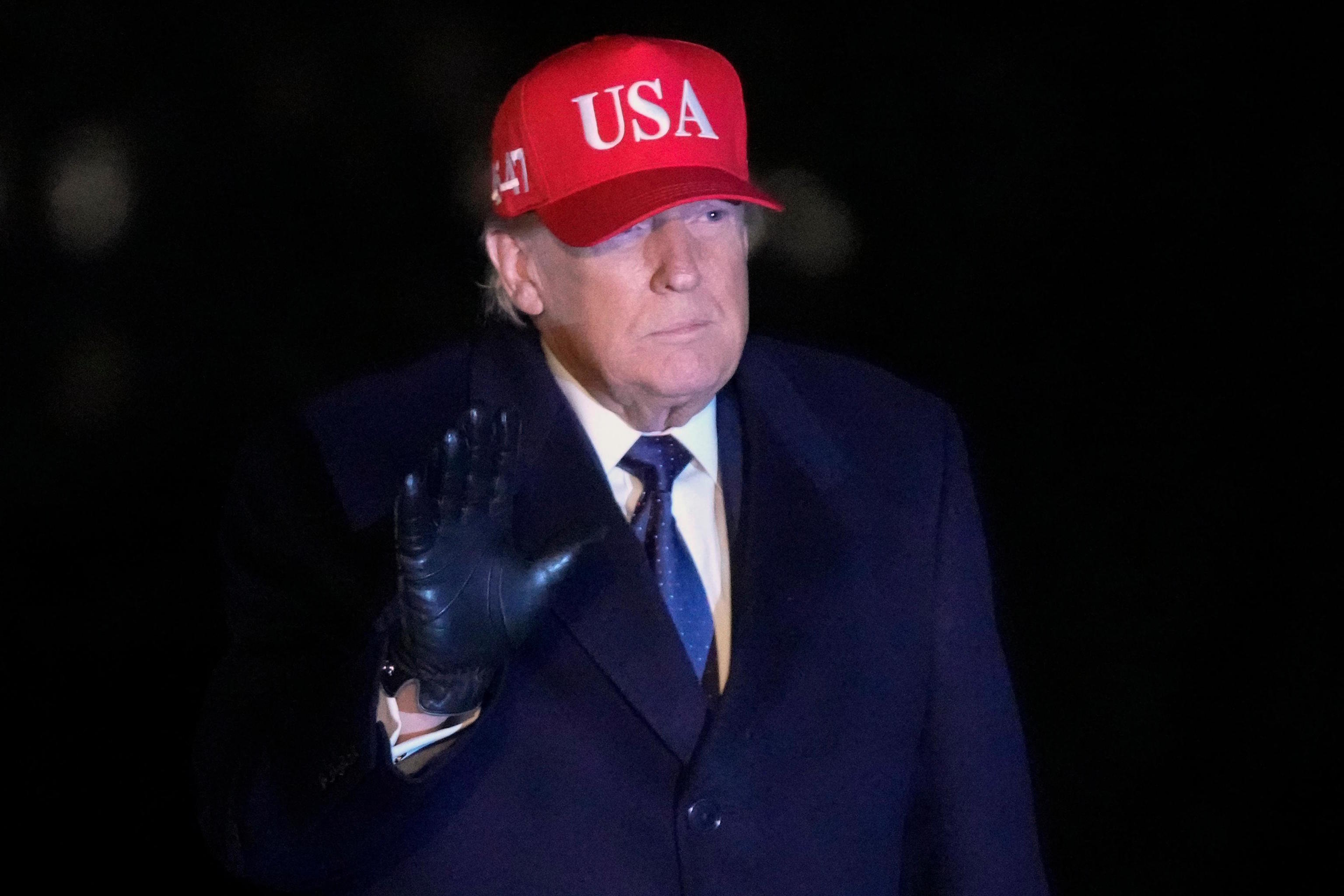 Trump waves after arriving on Marine One on the South Lawn of White House.