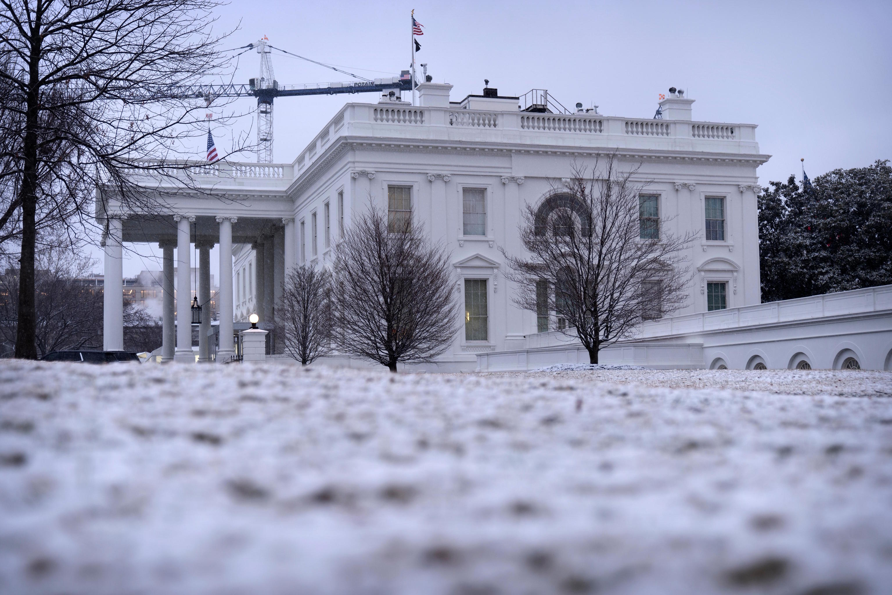Snow covers the ground at the White House.