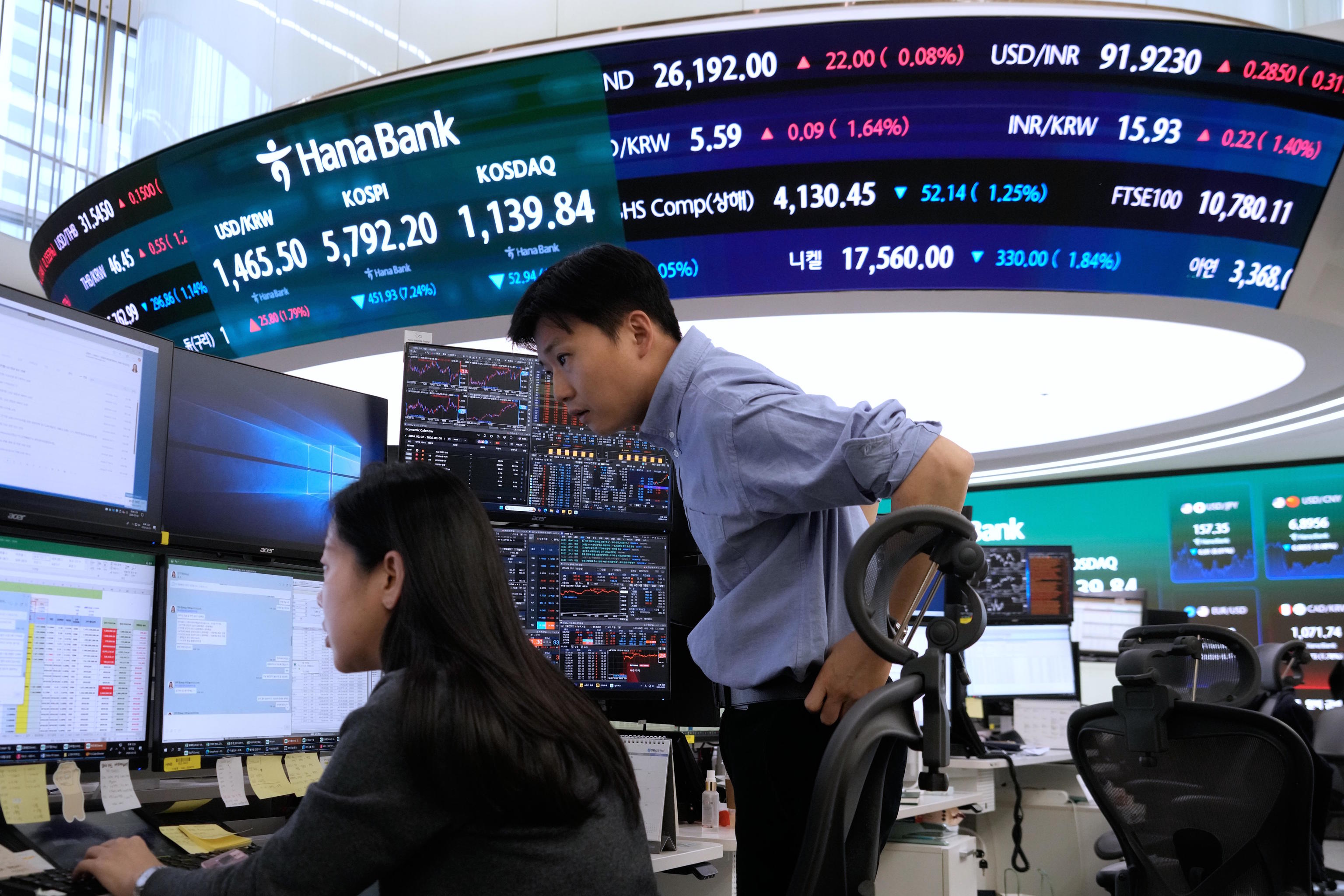 Currency traders work at the Hana Bank headquarters in Seoul.