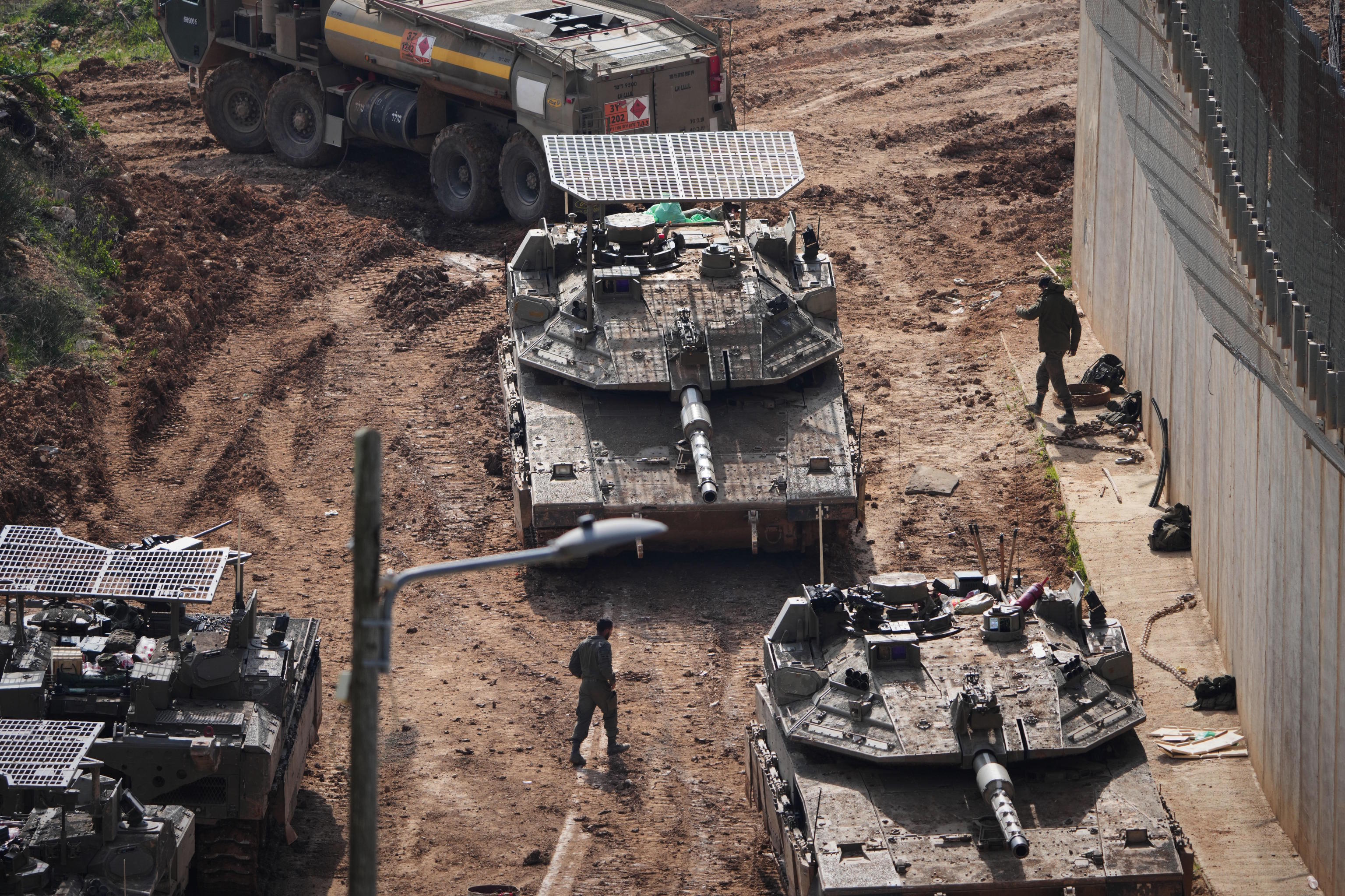 Israeli tanks maneuver near the Israel-Lebanon border.