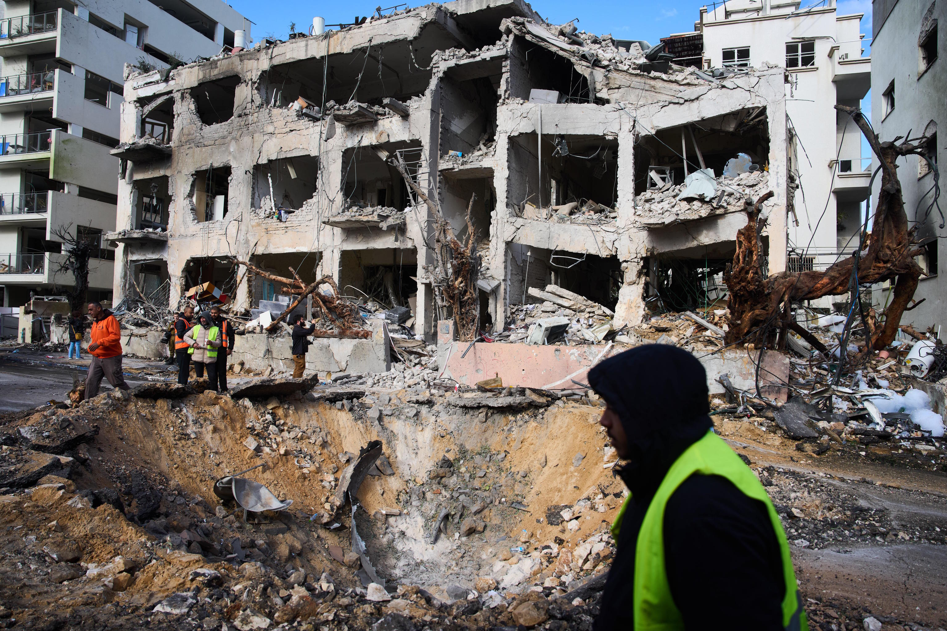 Rescue workers survey the scene of a direct hit in Tel Aviv.