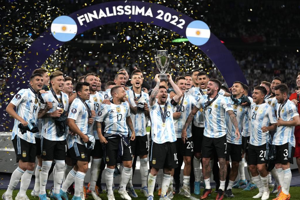 Argentina's Lionel Messi holds a trophy as he celebrates with his teammates after winning the Finalissima soccer match between Italy and Argentina at Wembley Stadium in London