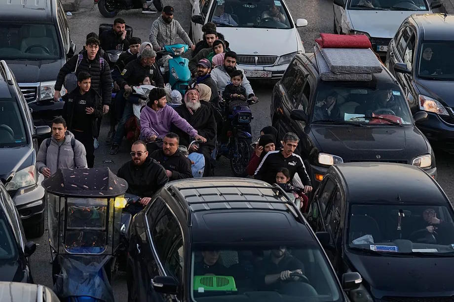 A crowd flees from the Dahiya neighborhood in Beirut.