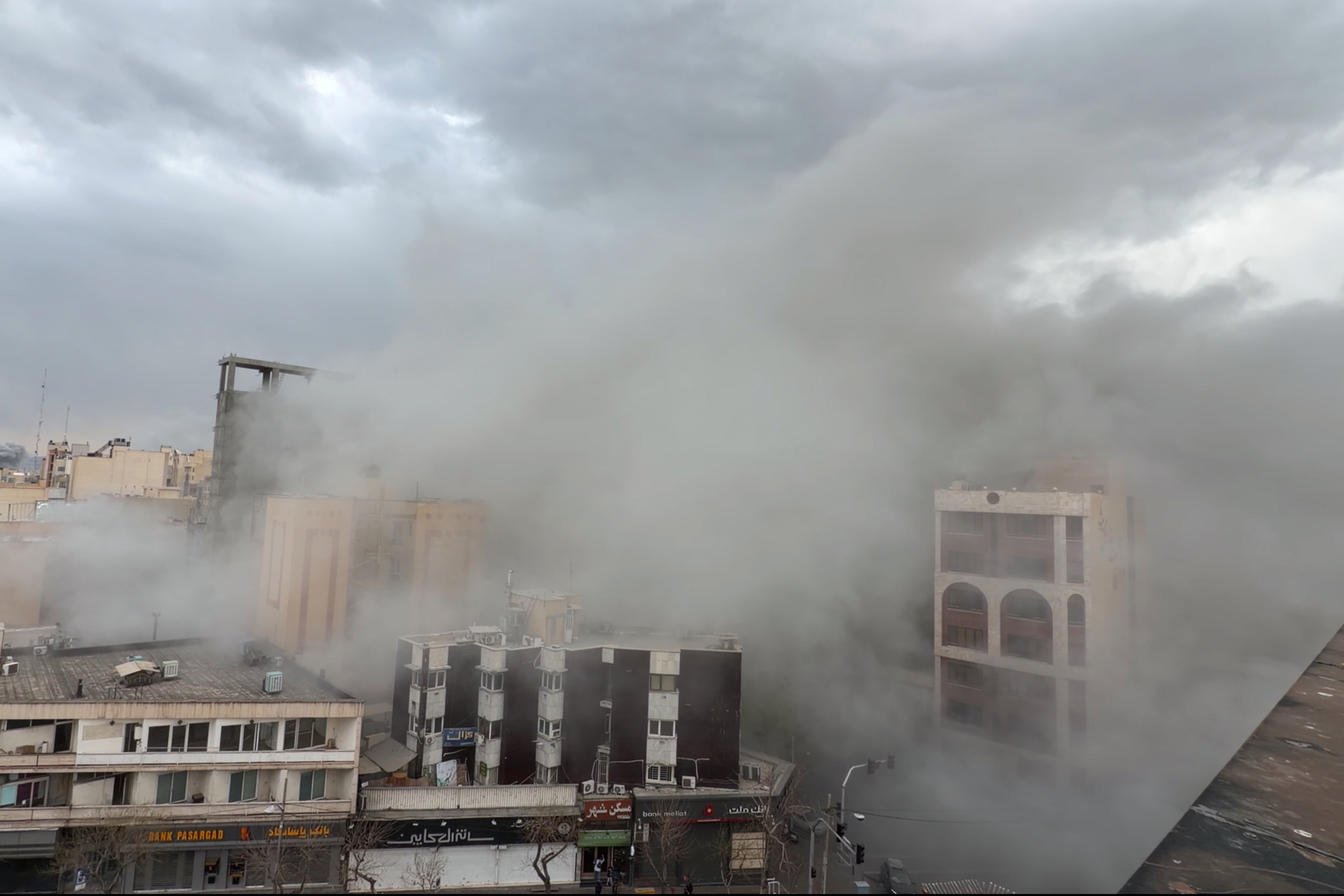 Smoke engulfs a street after a strike in Tehran.