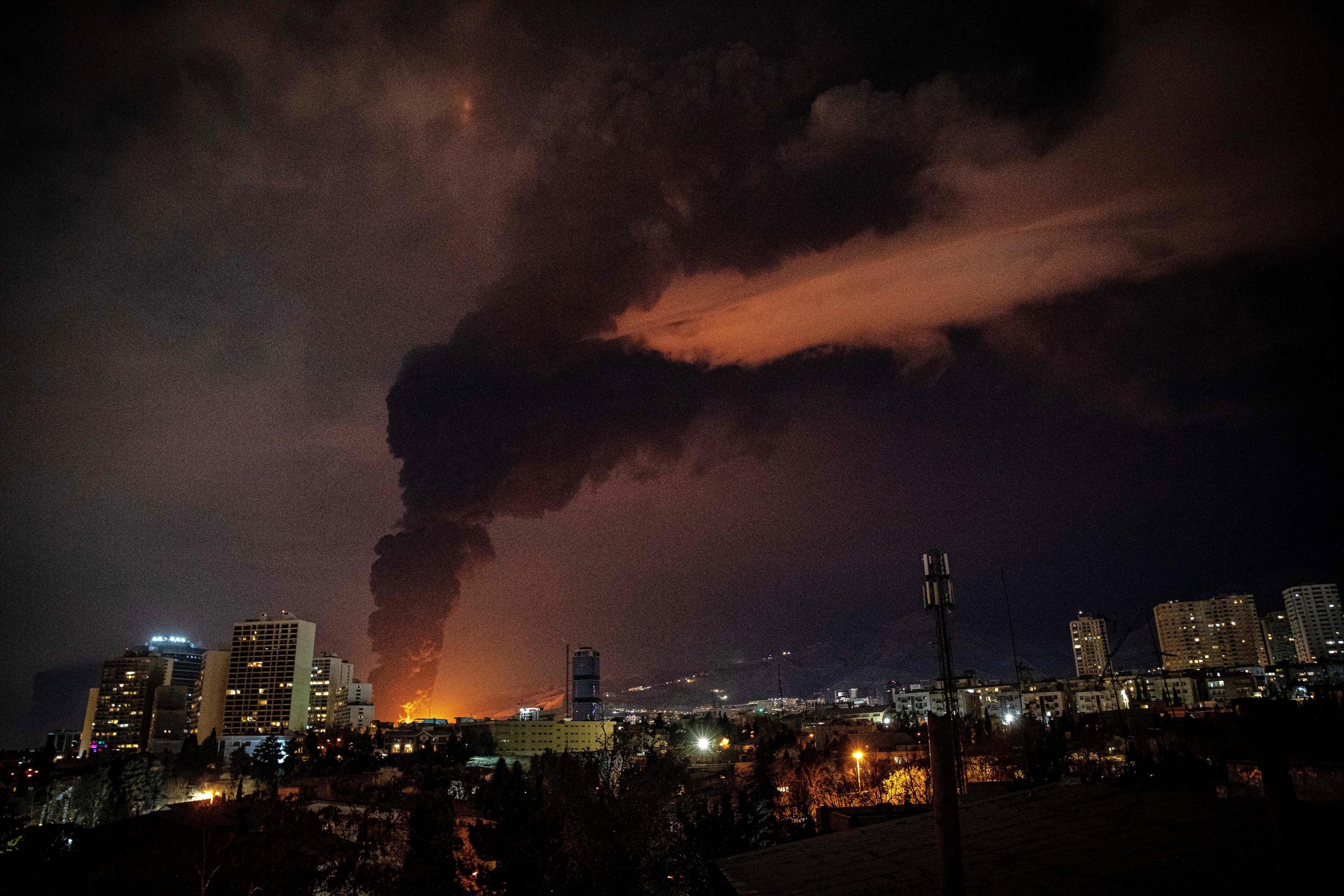 Flames and smoke rise from an oil storage in Tehran.