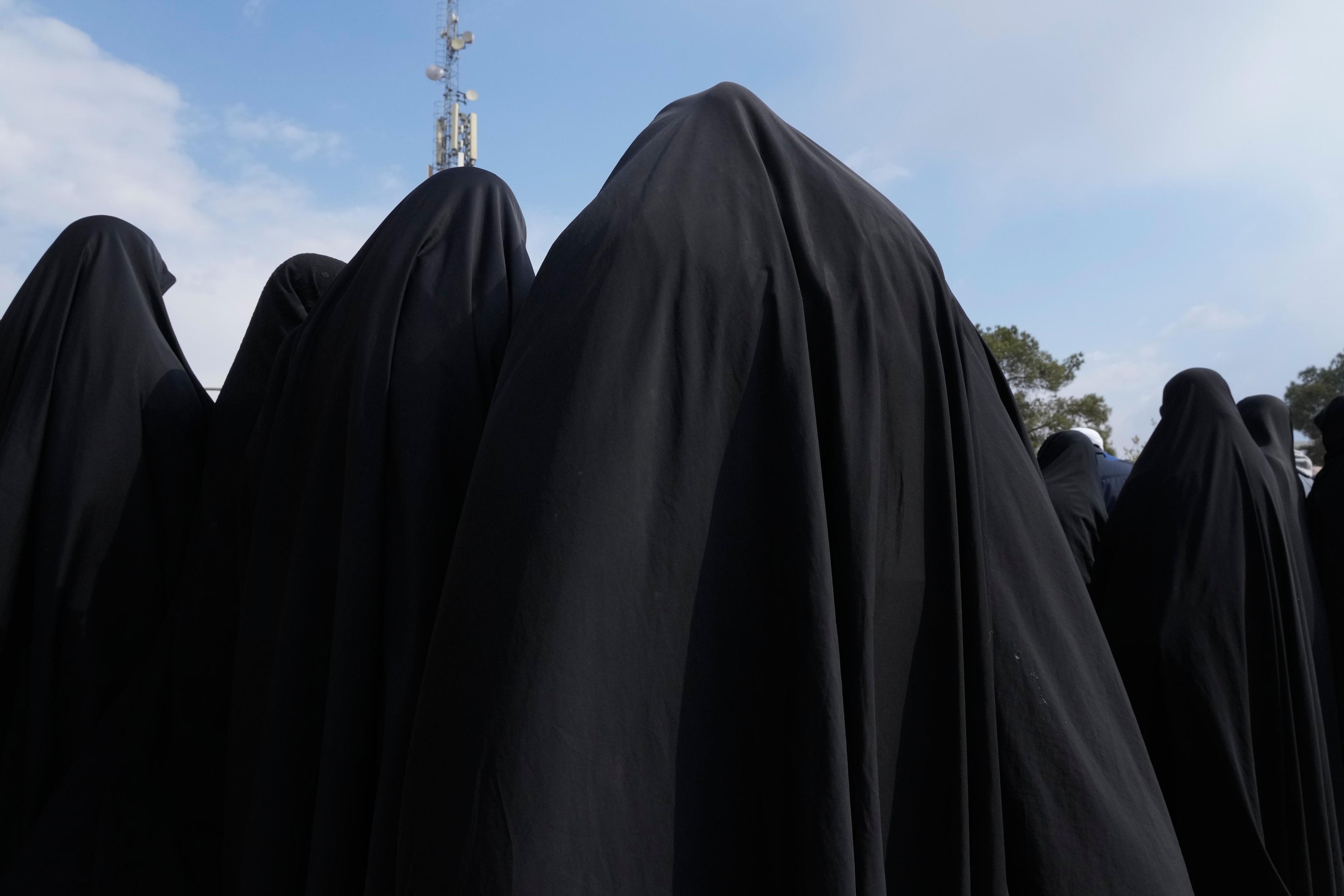 Women attend the burial ceremony at Behesht-e Zahra cemetery in Tehran.