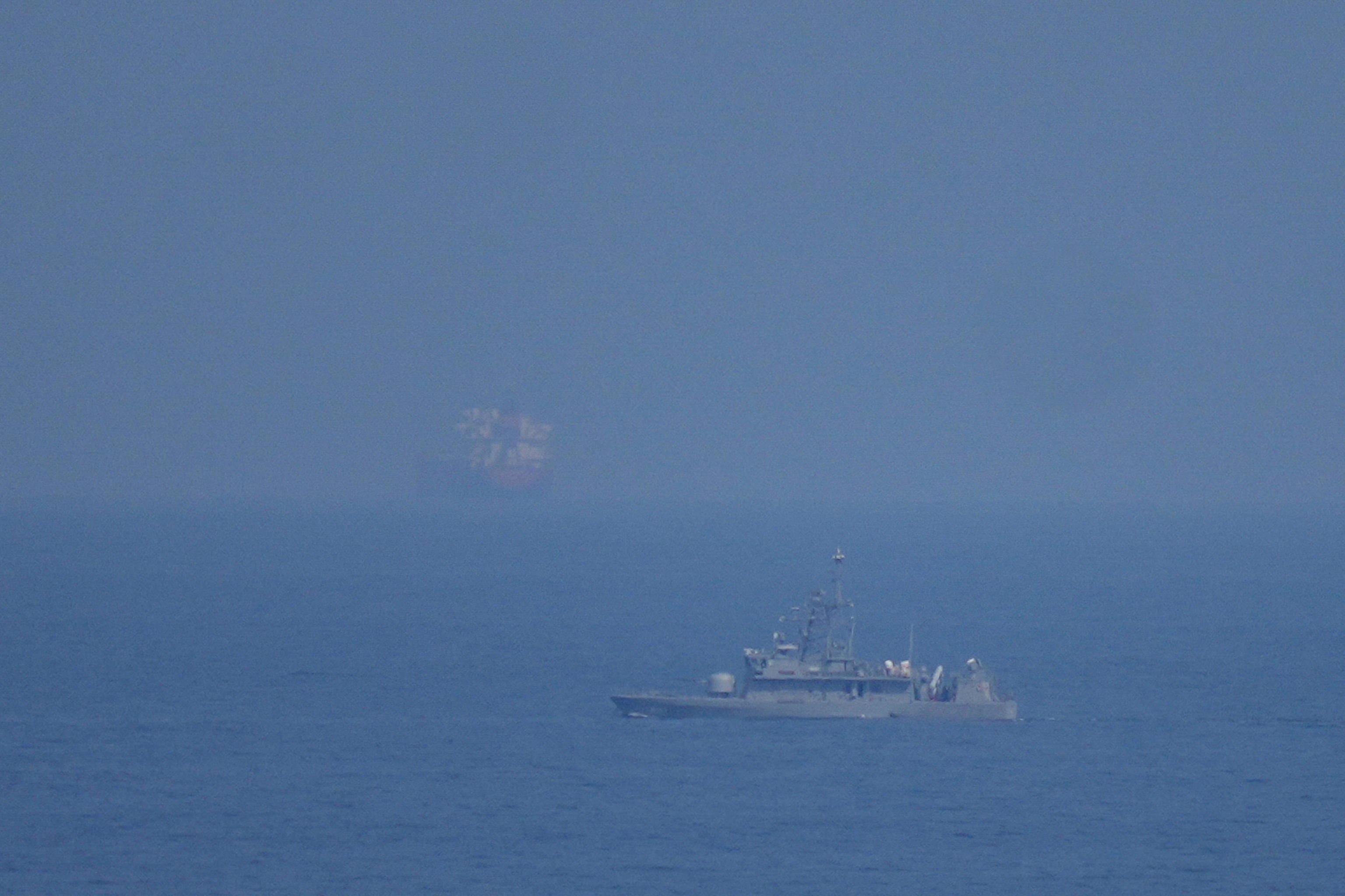 A UAE navy ship patrols the Strait of Hormuz as seen from Mina Al Fajer.