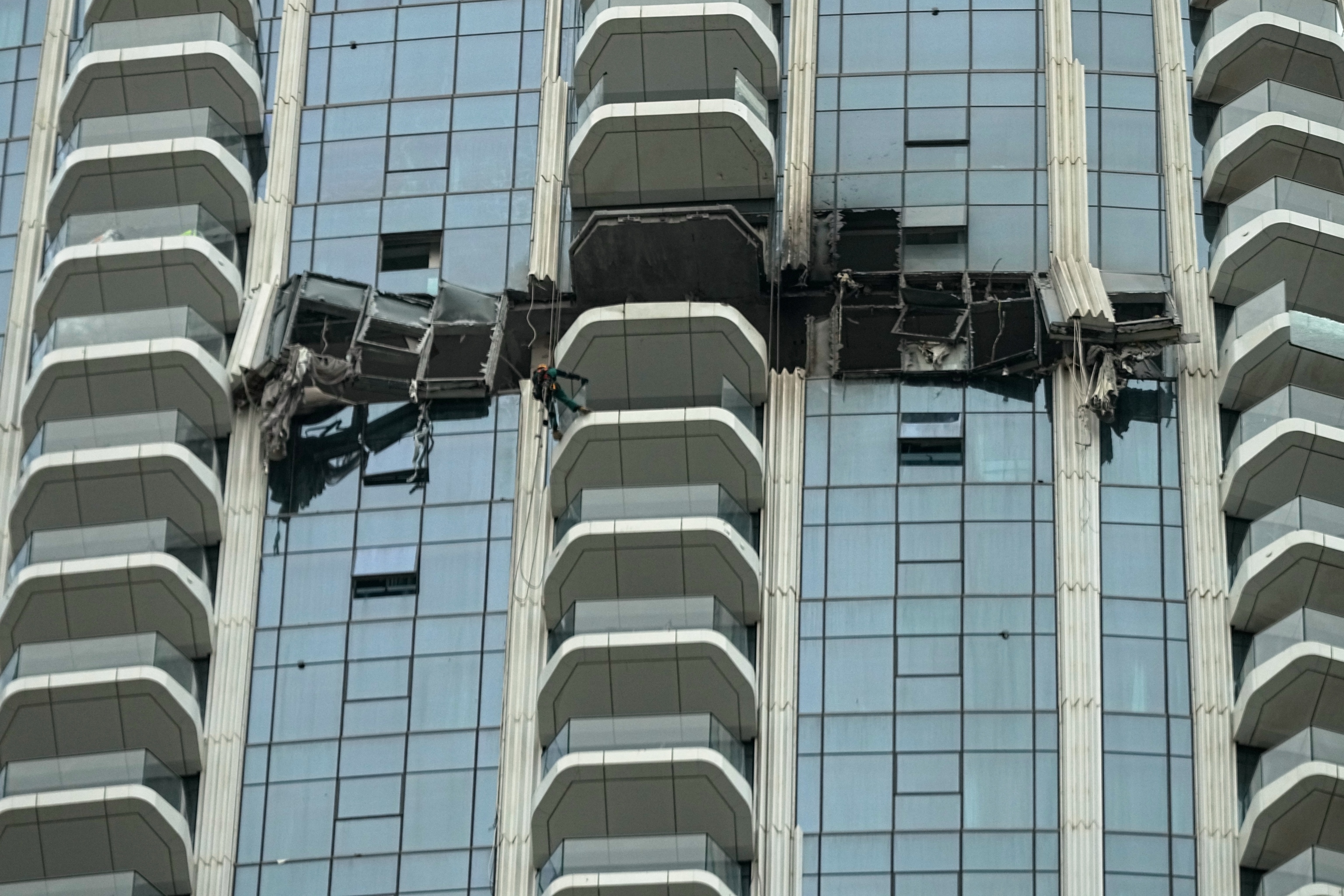 Workers inspect the damage at the Address Creek Harbour hotel after it was hit by a drone strike overnight in Dubai, United Arab Emirates.
