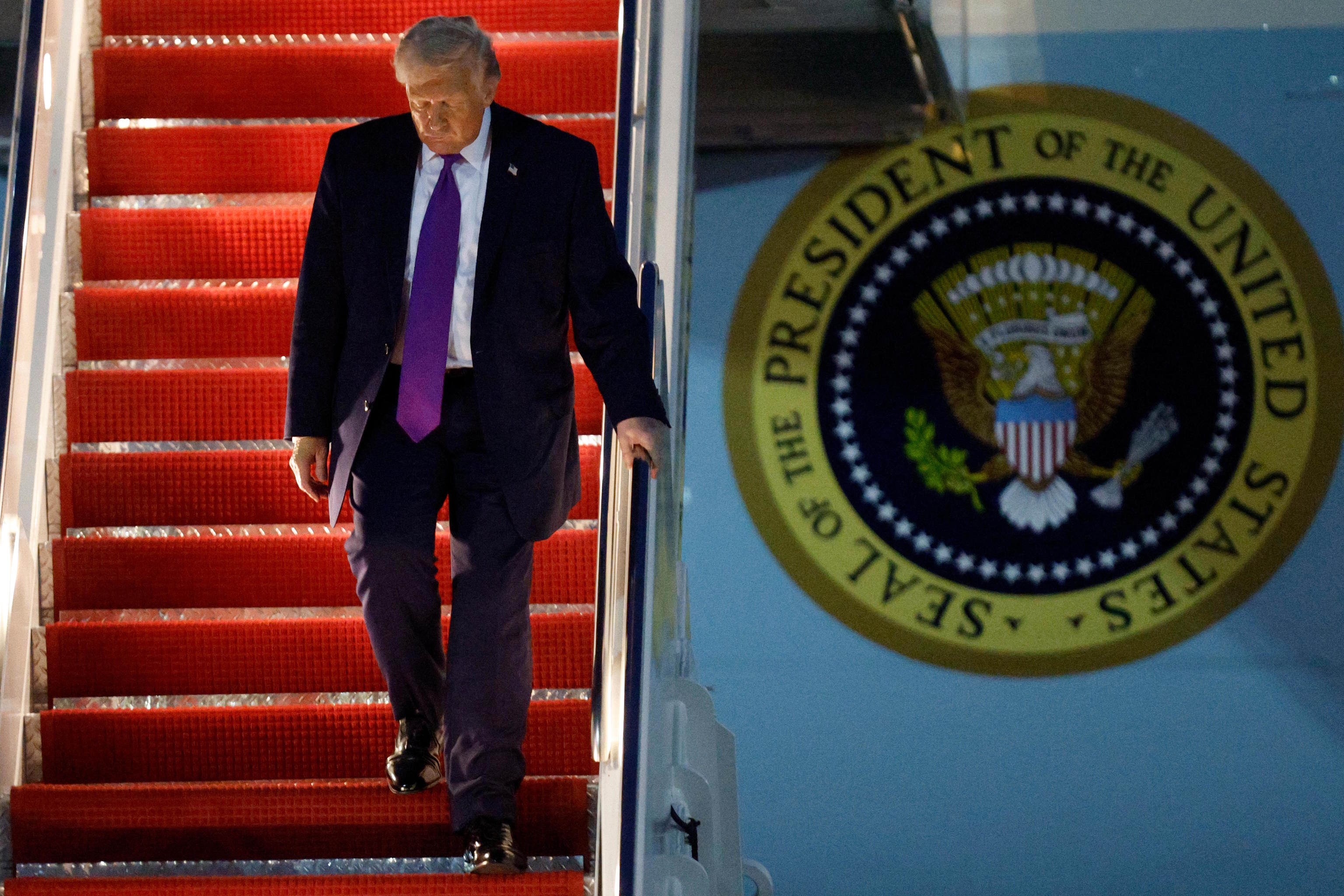 President Donald Trump walks down the stairs of Air Force One.