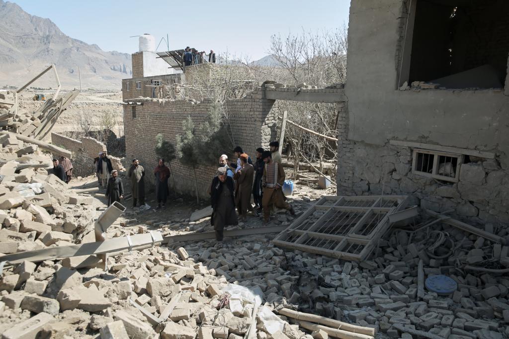 Residents inspect the site of a strike in Kabul, Afghanistan