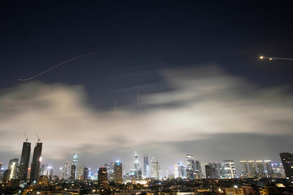 Israeli air defense system fires to intercept missiles during an Iranian attack over Tel Aviv