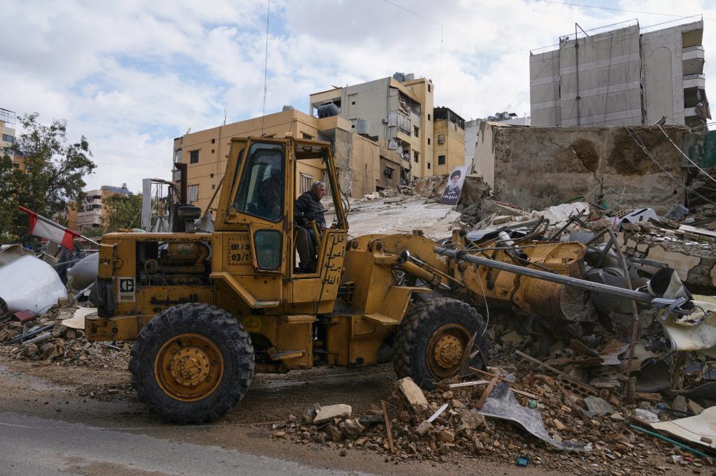 A bulldozer clears debris from the rubble of buildings destroyed in an Israeli airstrike
