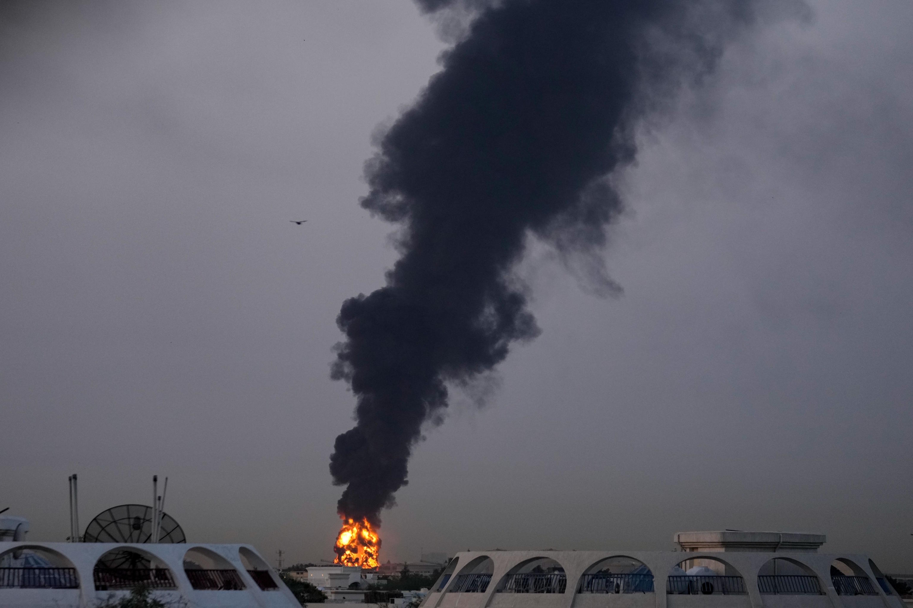 Fire and smoke rise after a drone hit a fuel depot at Dubai airport.