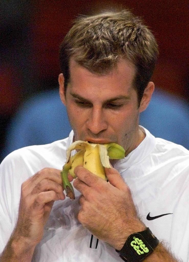 Tennis player Greg Rusedski eating a banana.