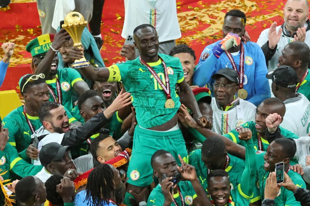 Senegal's Sadio Mane holds the trophy.