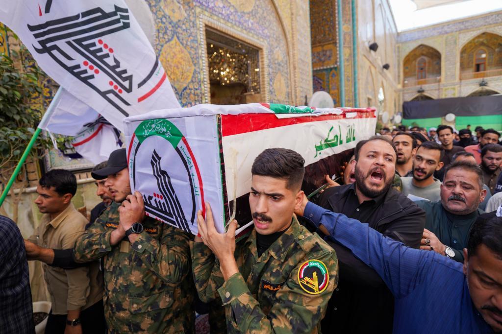 Members of the Popular Mobilization Forces attend the funeral of Iranian-backed Popular Mobilization Forces fighter killed in recent airstrikes