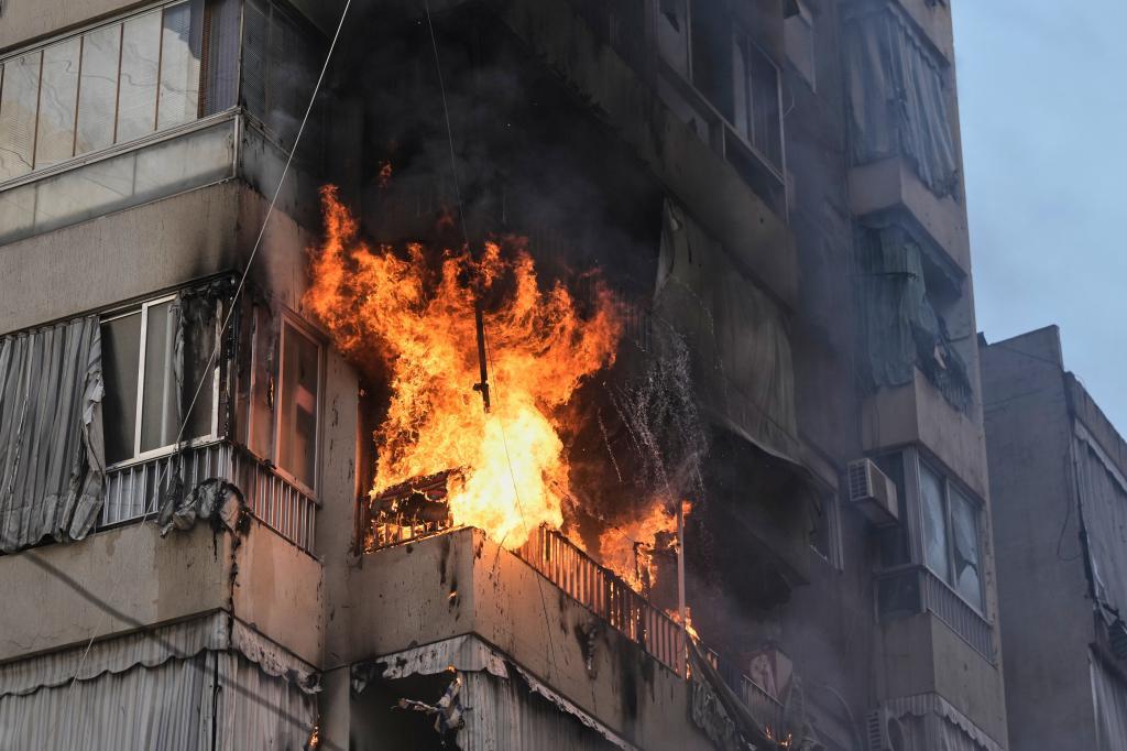Flames and smoke billow from a residential building following an Israeli attack in downtown Beirut.