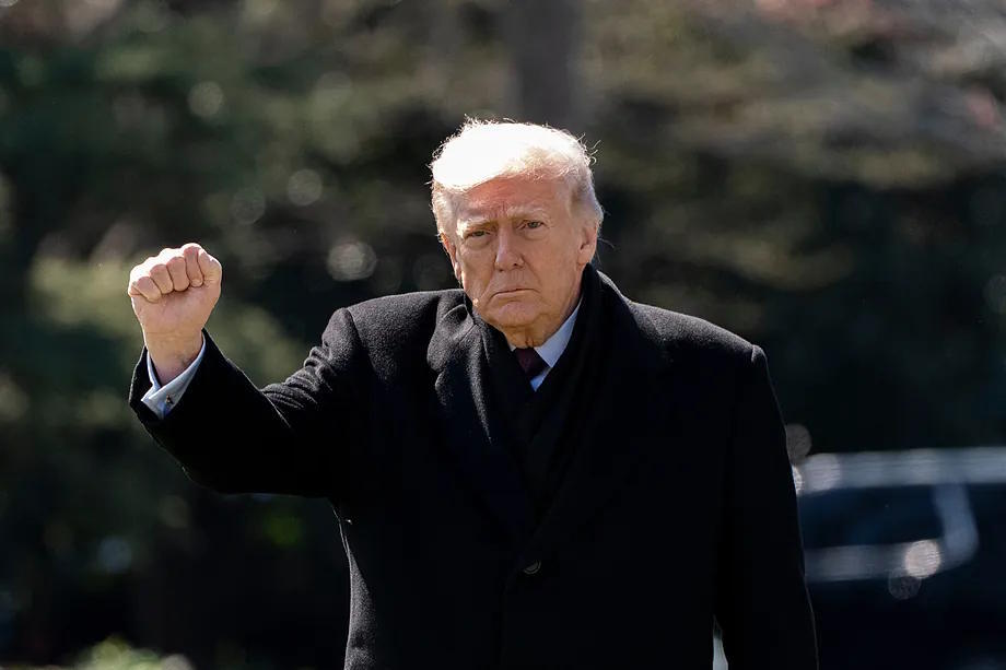 U.S. President, Donald Trump, raises his fist in Washington.