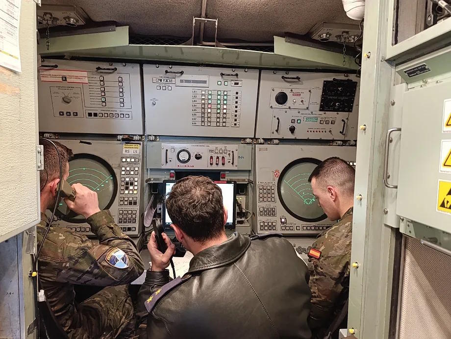Military personnel work on the radar.