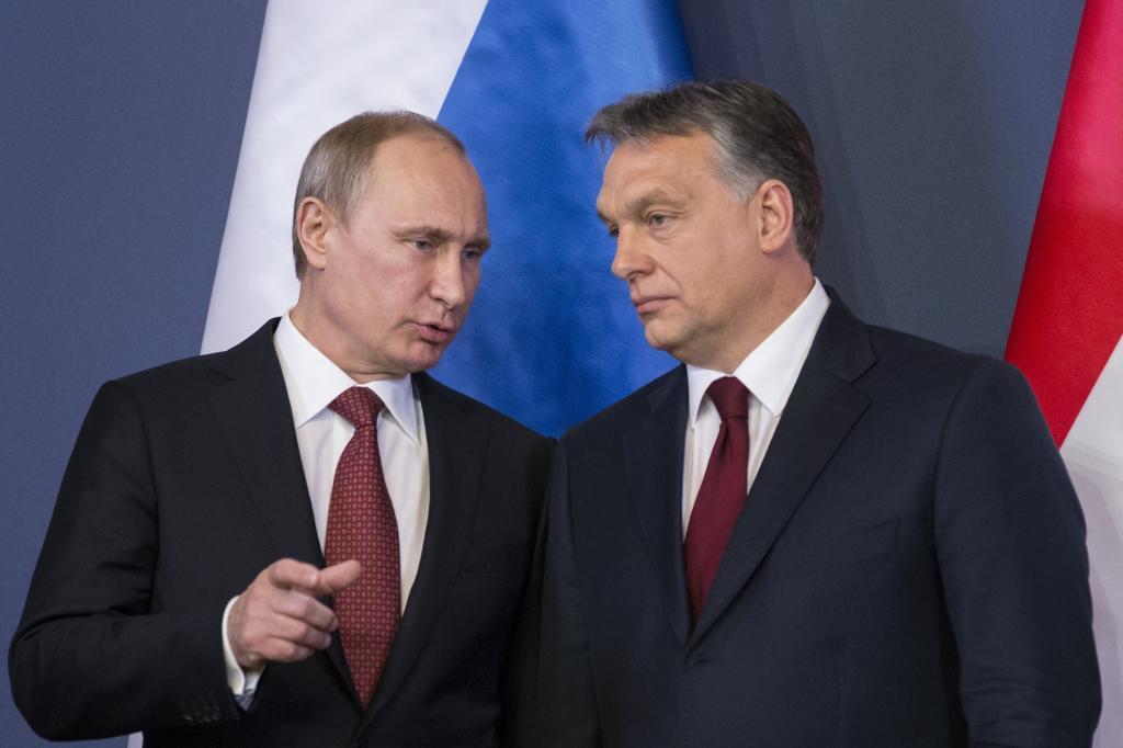 Russian President Vladimir Putin, left, speaks to Hungarian Prime Minister Viktor Orban