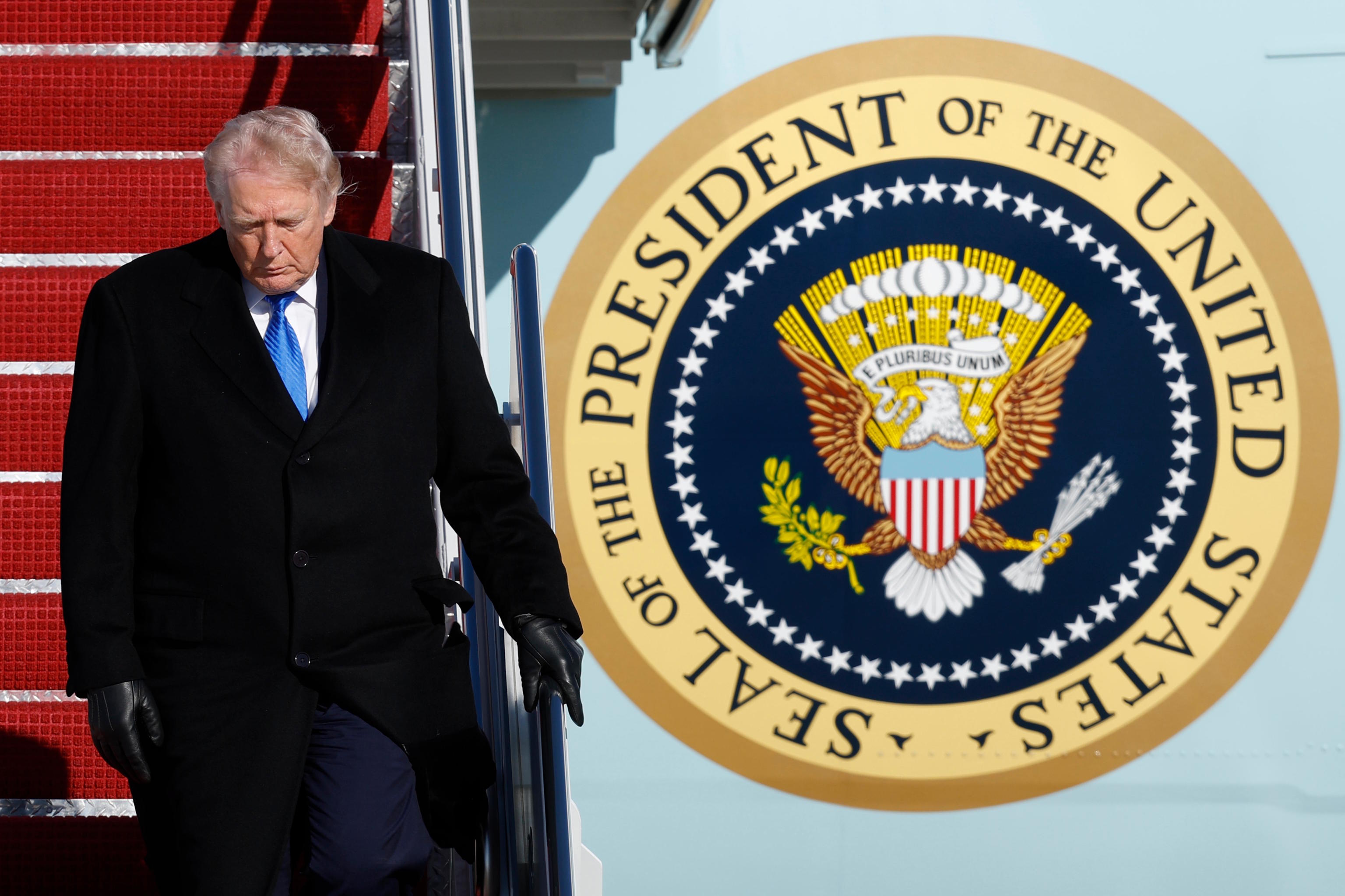 President Donald Trump walks down the stairs of Air Force One.