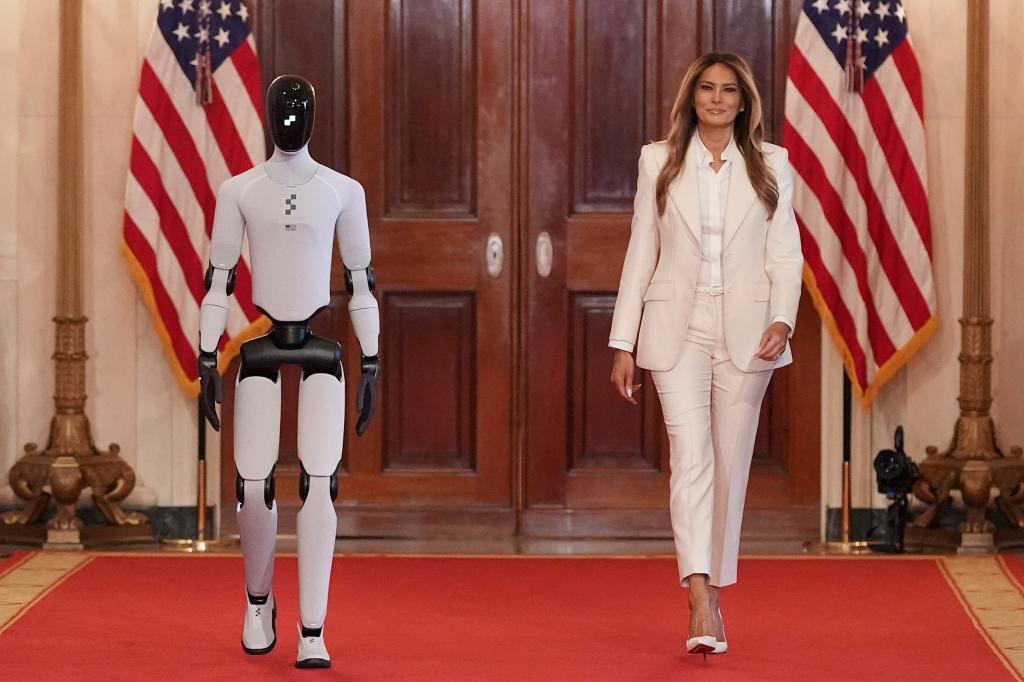 First lady Melania Trump arrives, accompanied by a robot