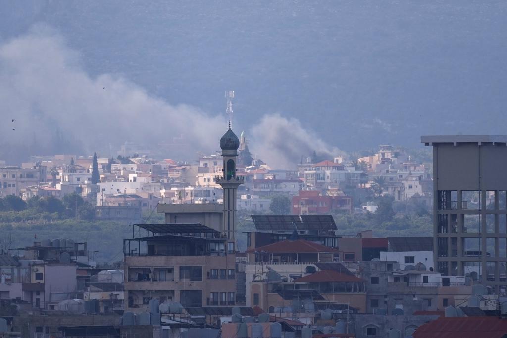 Some rising from an Israeli airstrike that hit Qlaileh village, is seen from Tyre city, south Lebanon