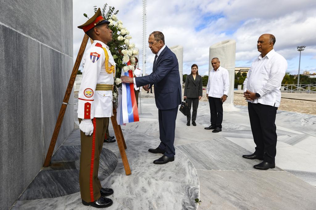 Russia's Foreign Minister Sergey Lavrov, center, places a wreath at the Jose Marti Monument in Havana, Cuba