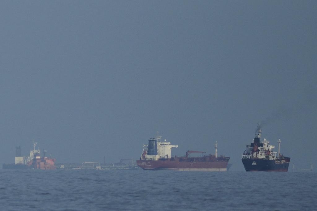Oil tankers and cargo ships line up in the Strait of Hormuz