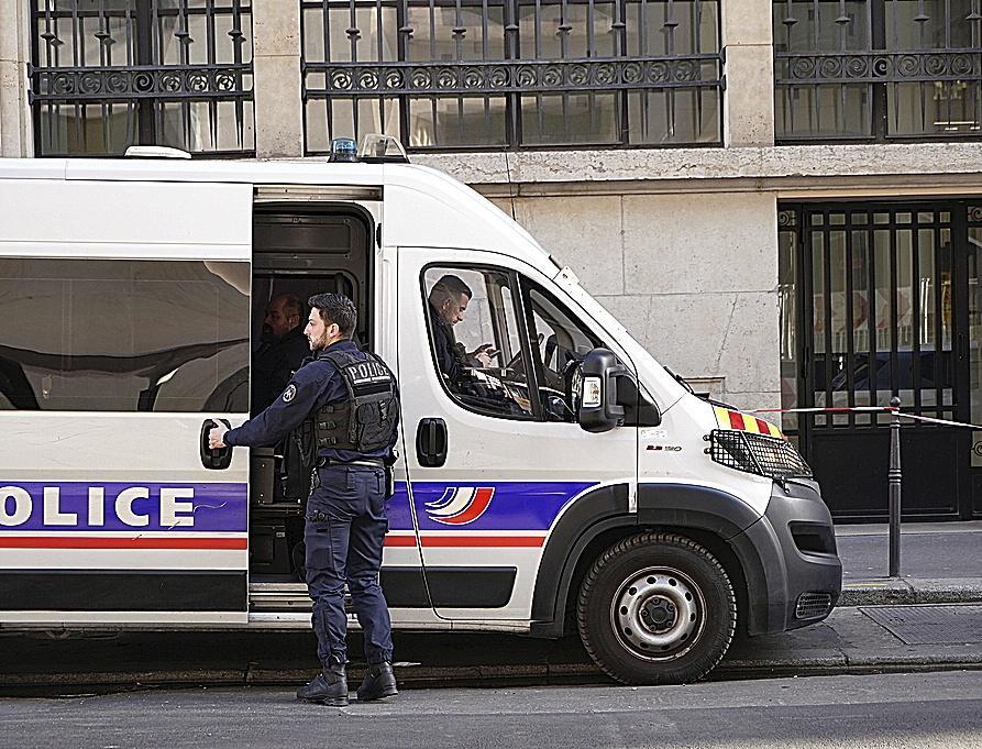 Police stand outside the Bank of America building in Paris