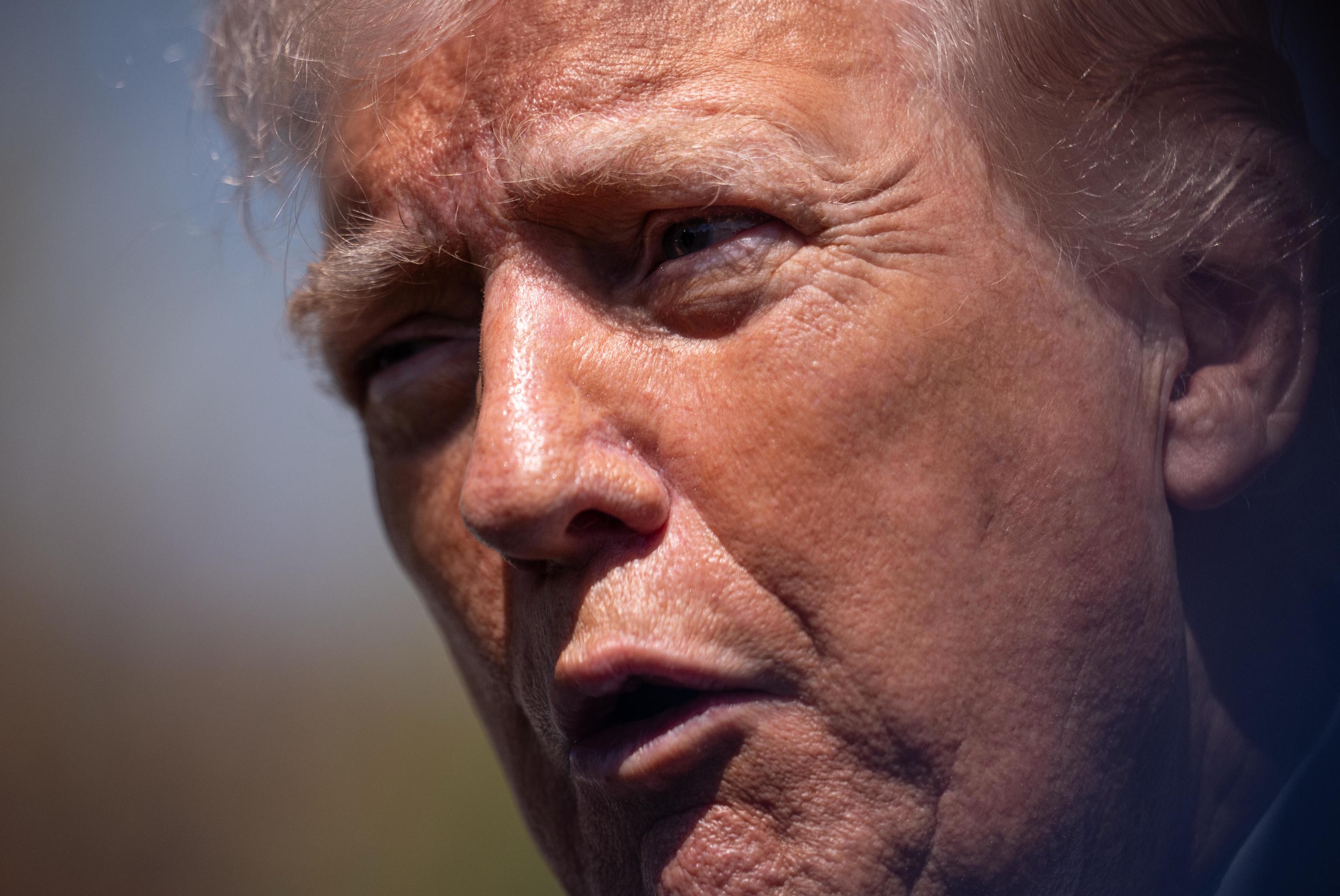President Donald Trump speaks with reporters.