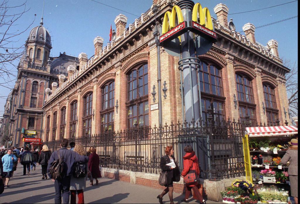 People on the street in front of the McDonald's restaurant at the Budapest train station