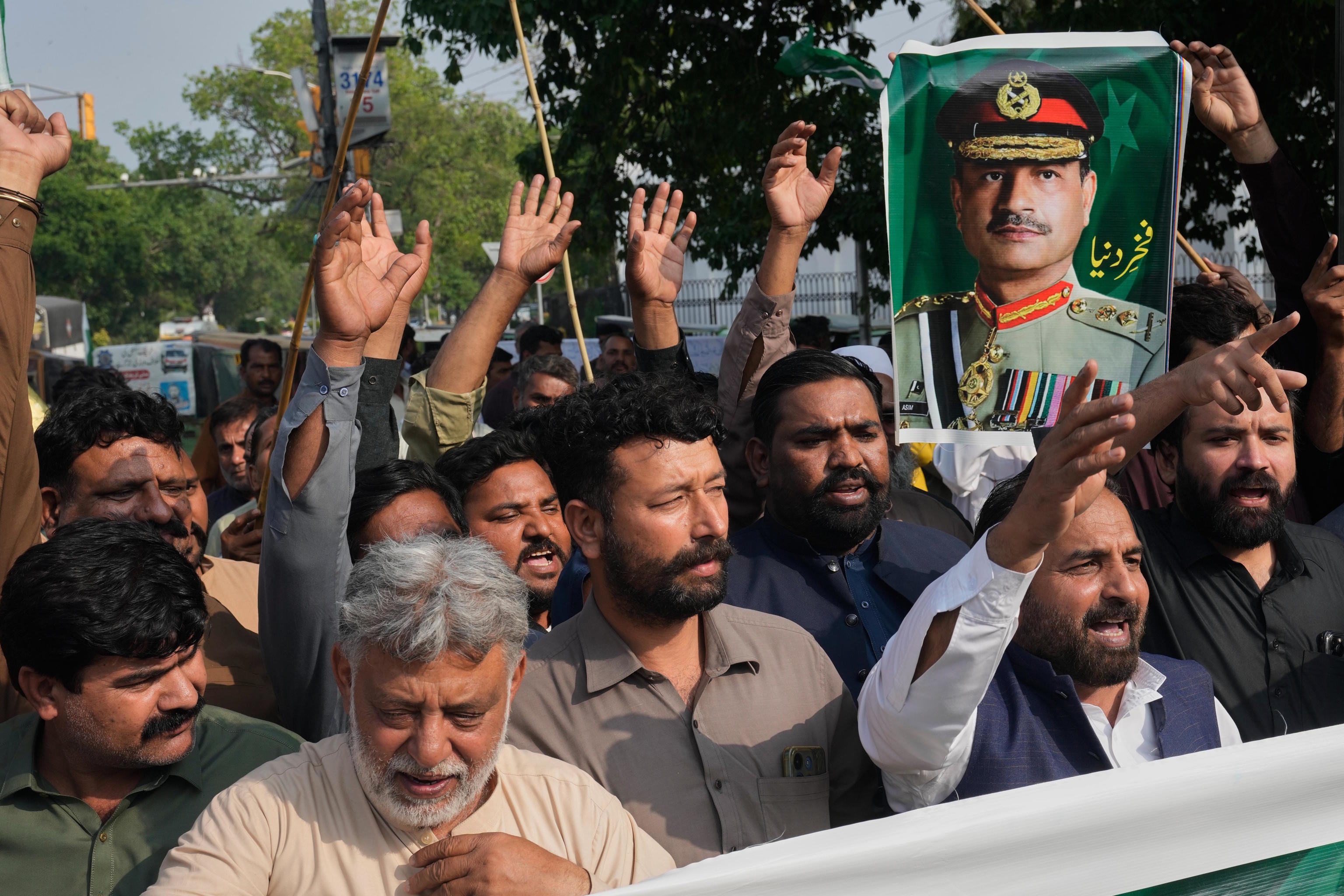 Supporters carry a portrait of Pakistan Army Chief Field Marshal Asim Munir.