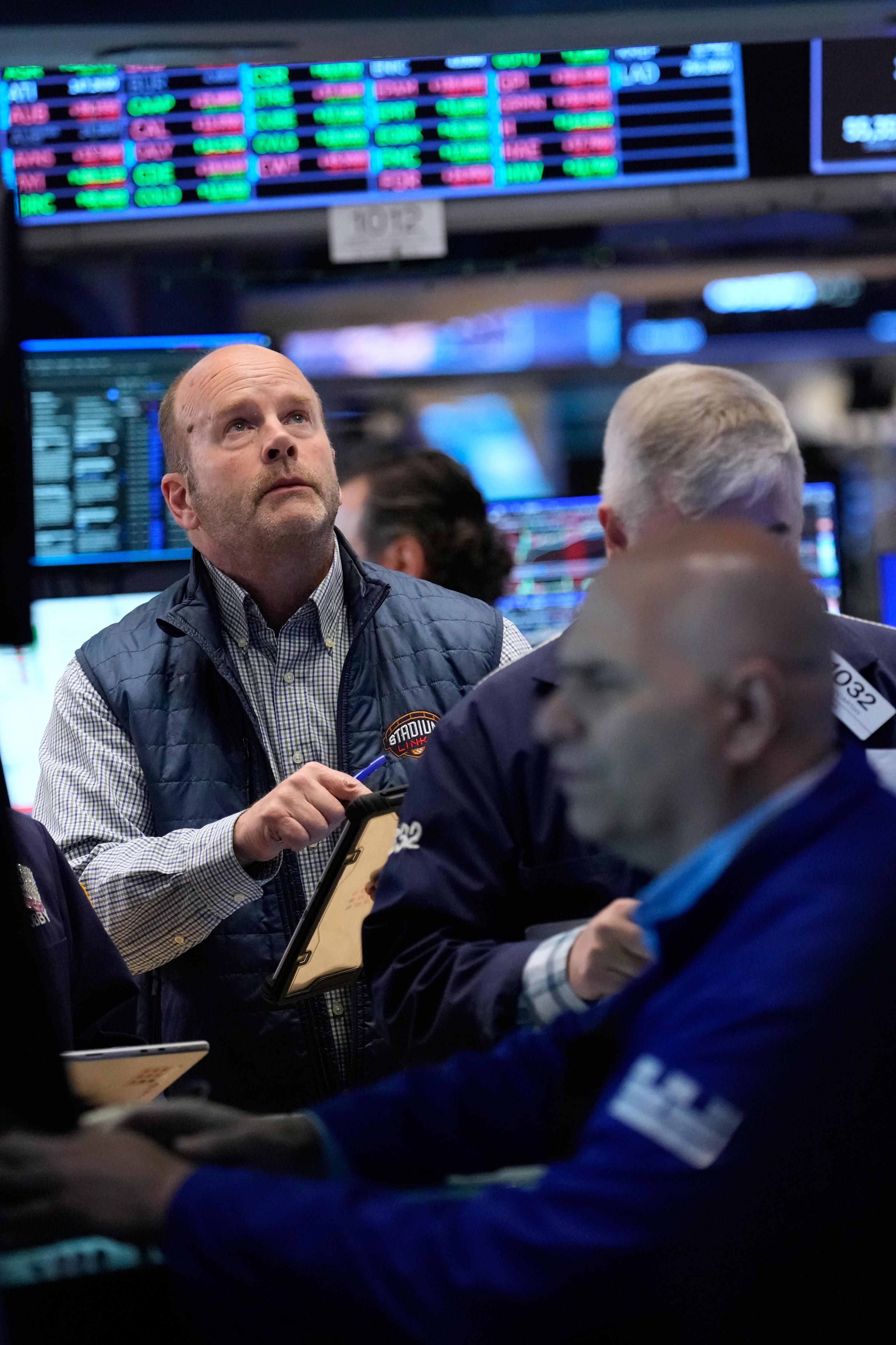 Traders work on the floor at the New York Stock Exchange in New York.