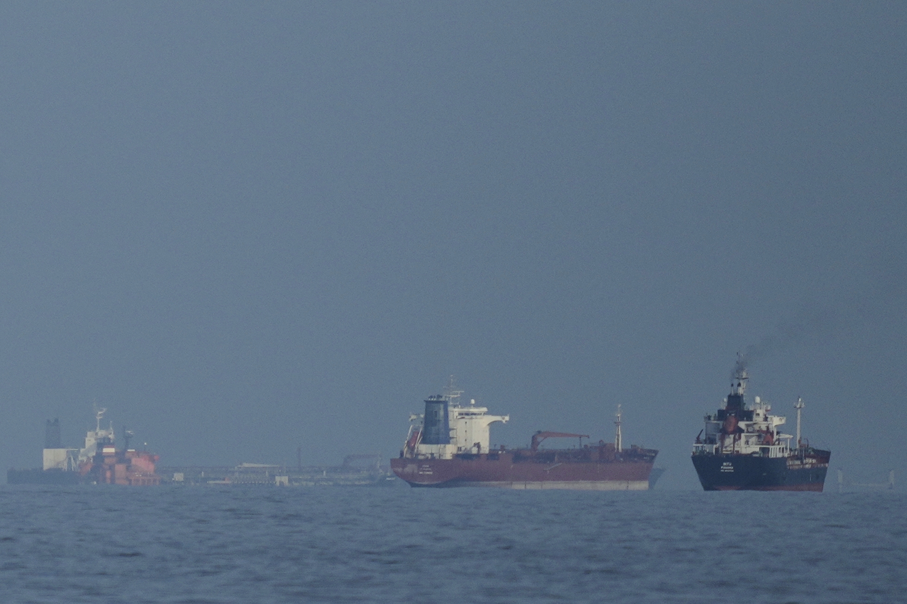 Oil tankers and cargo ships line up in the Strait of Hormuz.