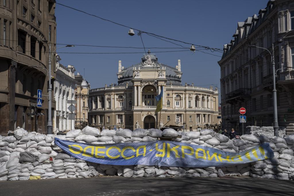Sandbags block a street in front of the National Academic Theatre of Opera and Ballet building