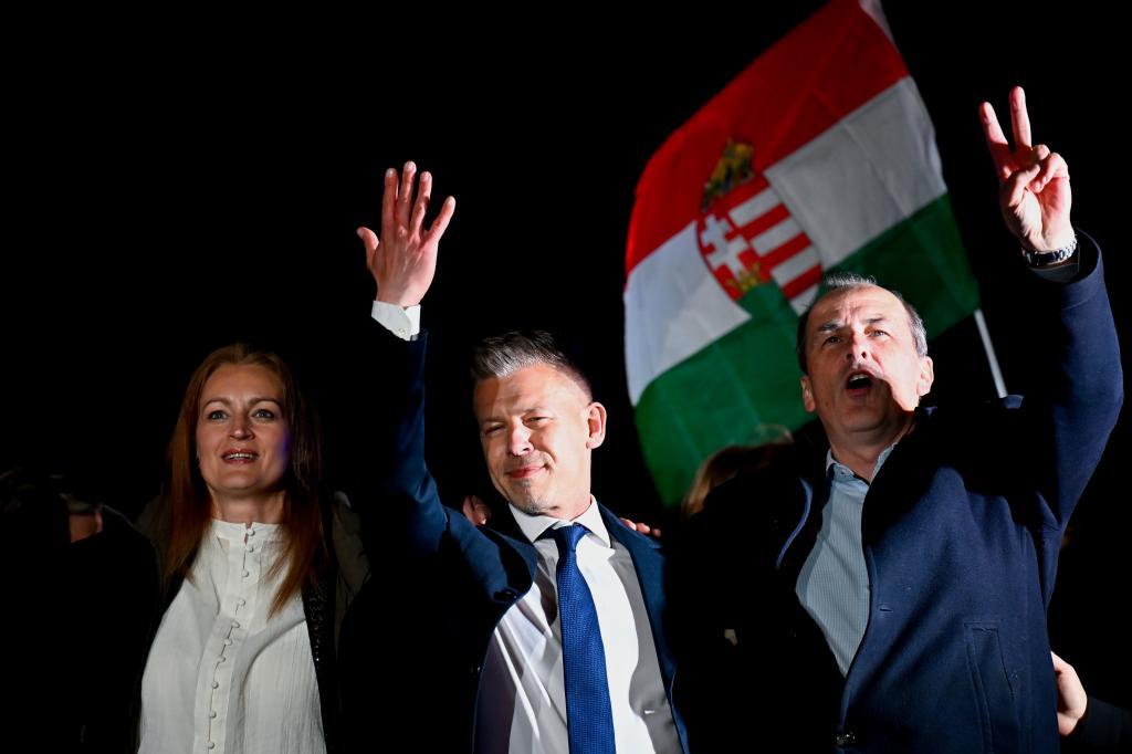 Peter Magyar, leader of the opposition Tisza party, waves the Hungarian flag
