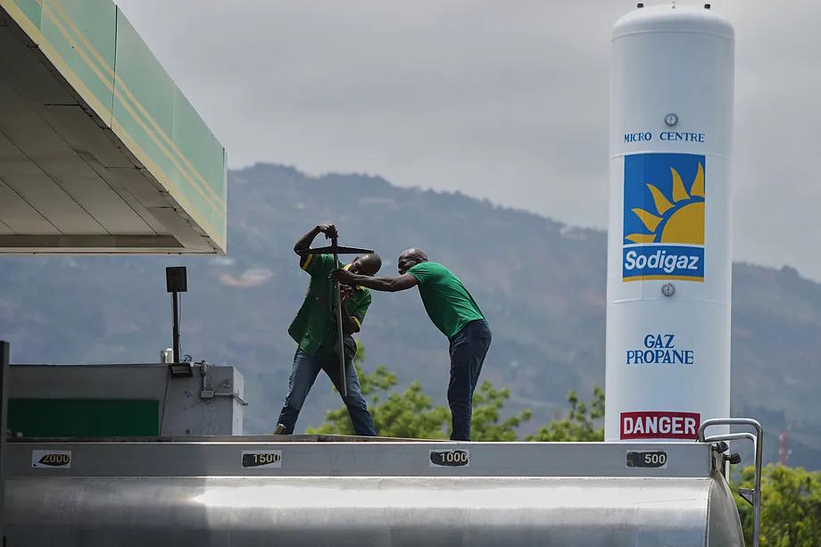 Gas station employees prepare to fill a fuel tank in Port-au-Prince, Haiti.