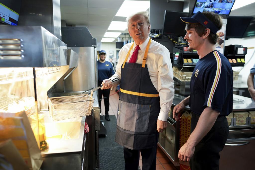 President Donald Trump works behind the counter during a visit to McDonald's