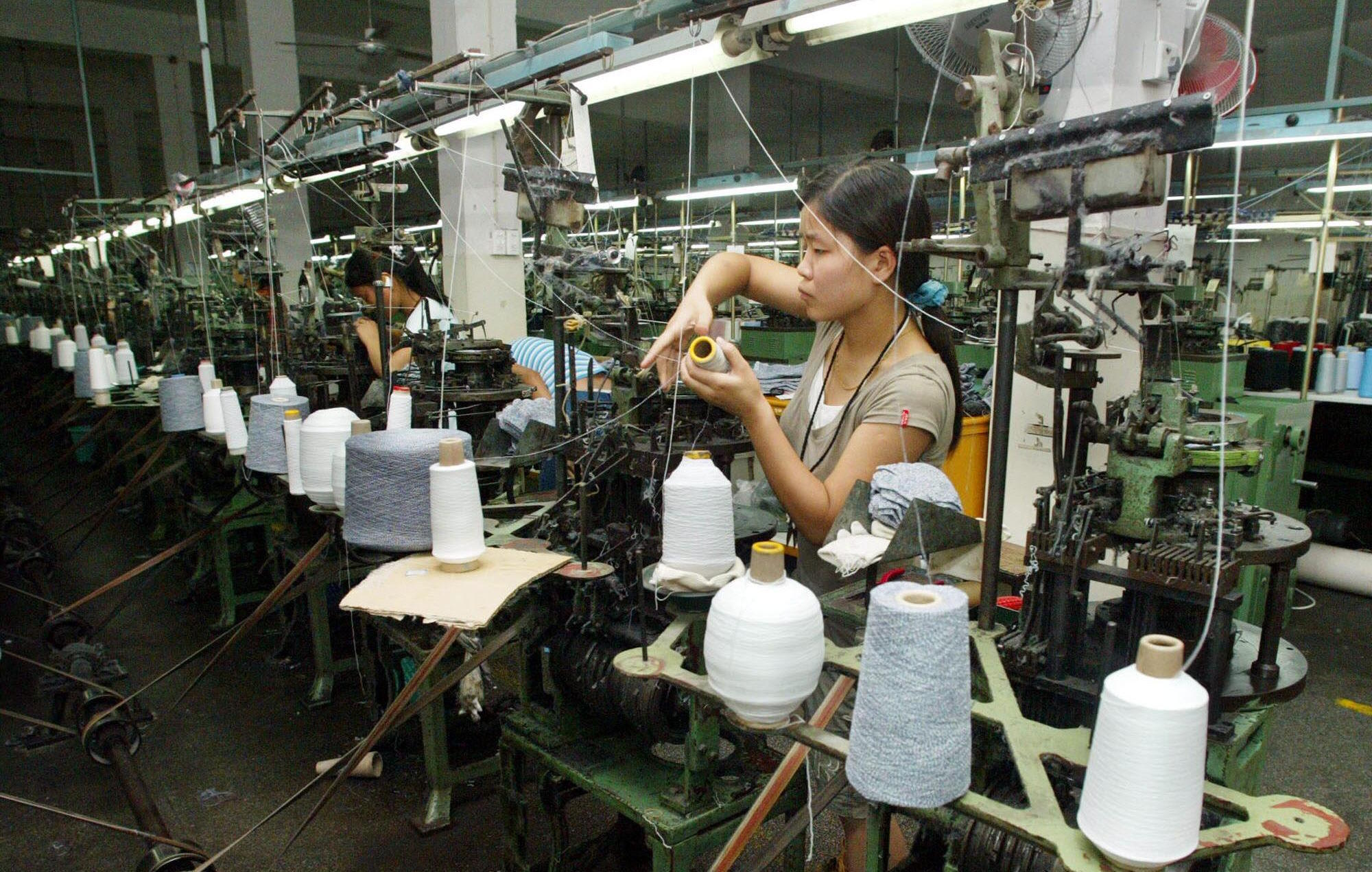 A Chinese woman works at a textile factory in Shaoxing, Province China.