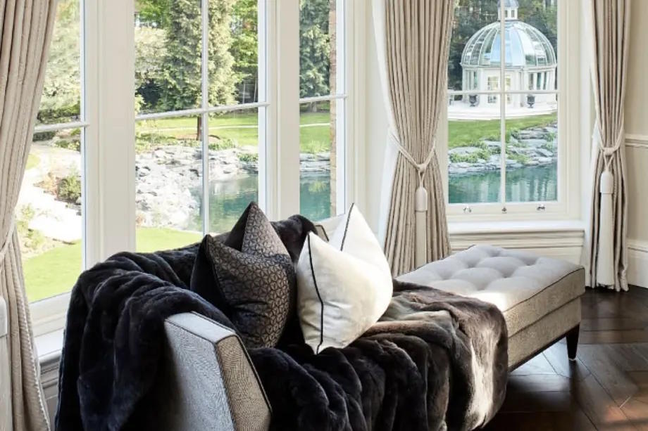 The luxurious living room of Providence House with a lake in the background.