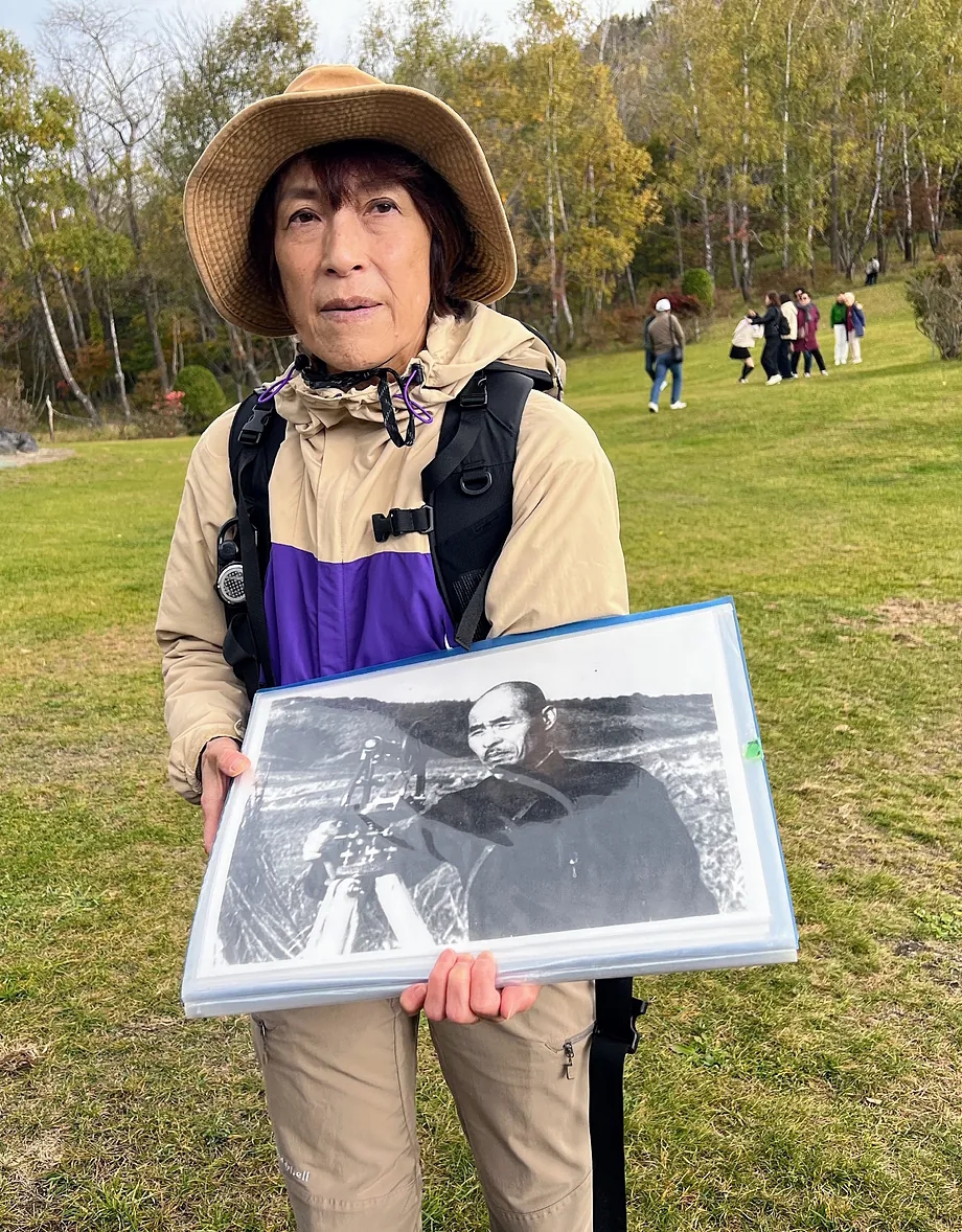 Local guide Rie Egawa shows a picture of Masao Mimatsu, the postman and amateur volcanologist who bought the Showa Shinzan