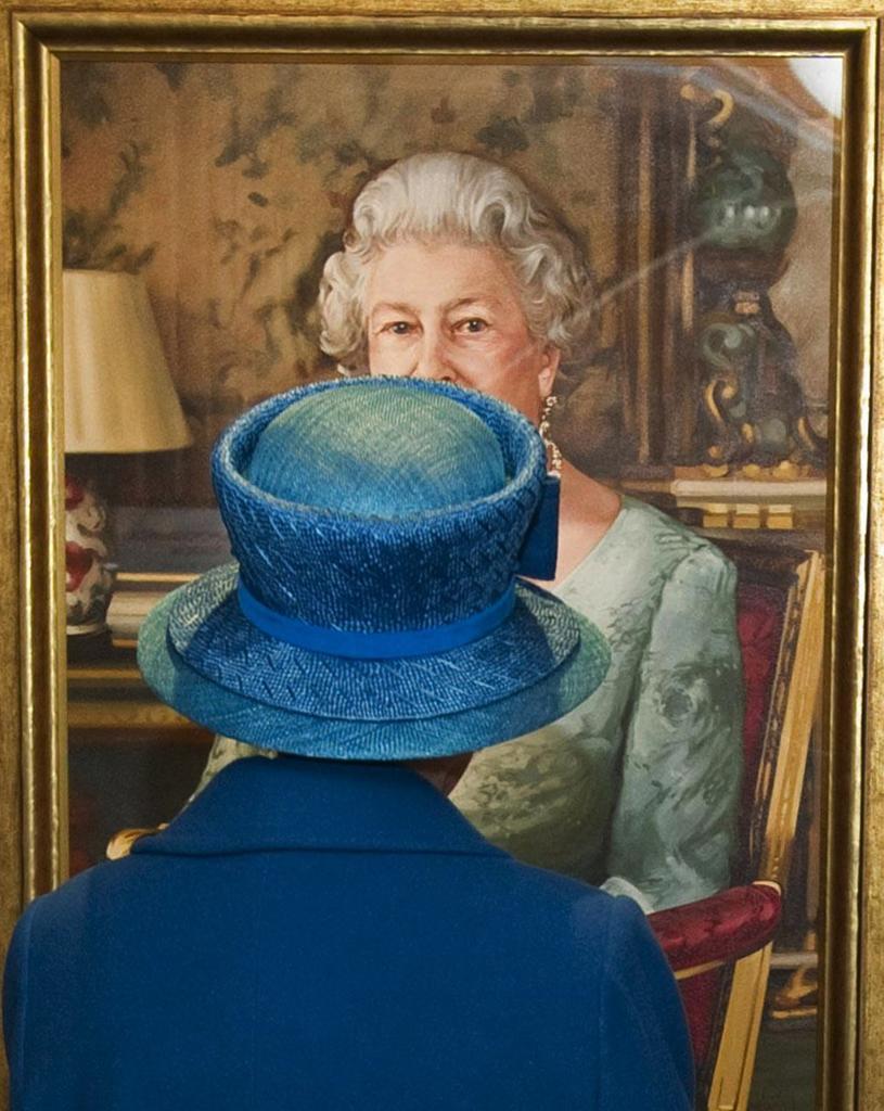 Britain's Queen Elizabeth II views a portrait.