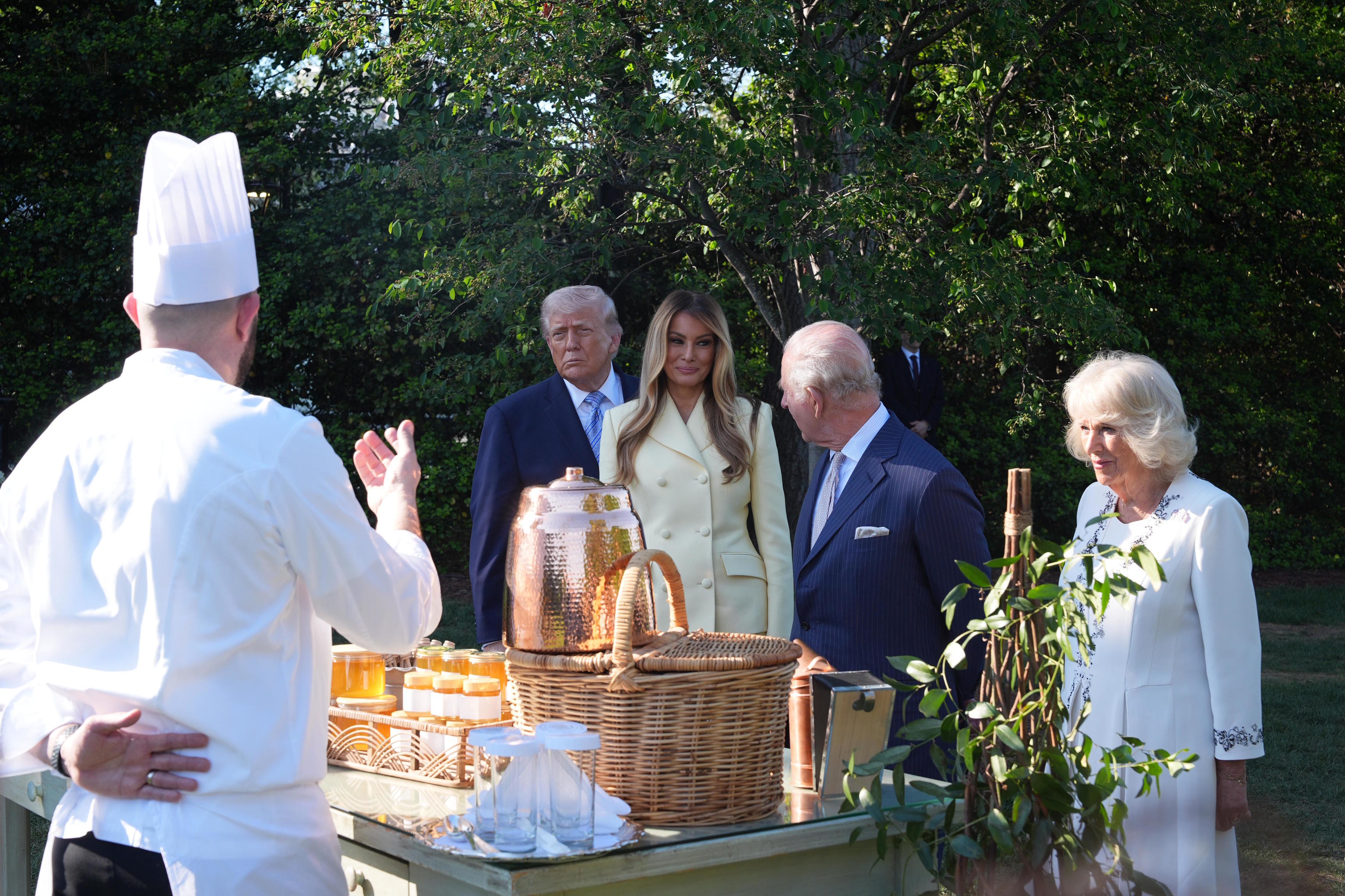 President Trump and first lady Melania and Britain's King Charles III and Queen Camilla talk with White House assistant pastry chef Carlo Figarella.