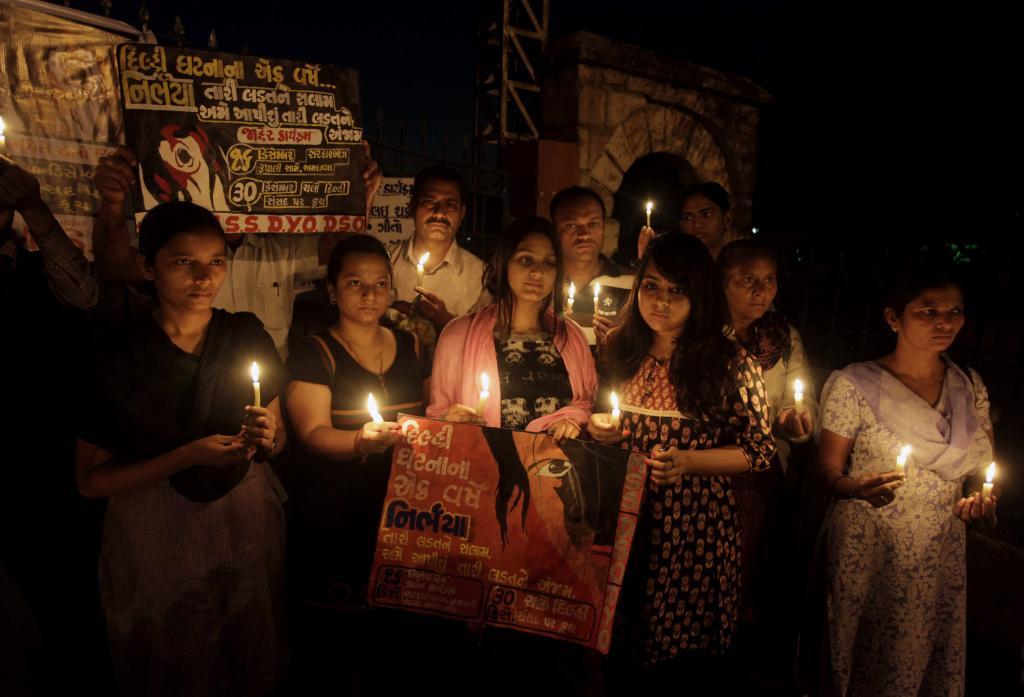 Indian people hold candles to pay tribute to last year's gang rape and murder of a young woman in New Delhi
